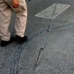 Power pole guy wire in the sidewalk.