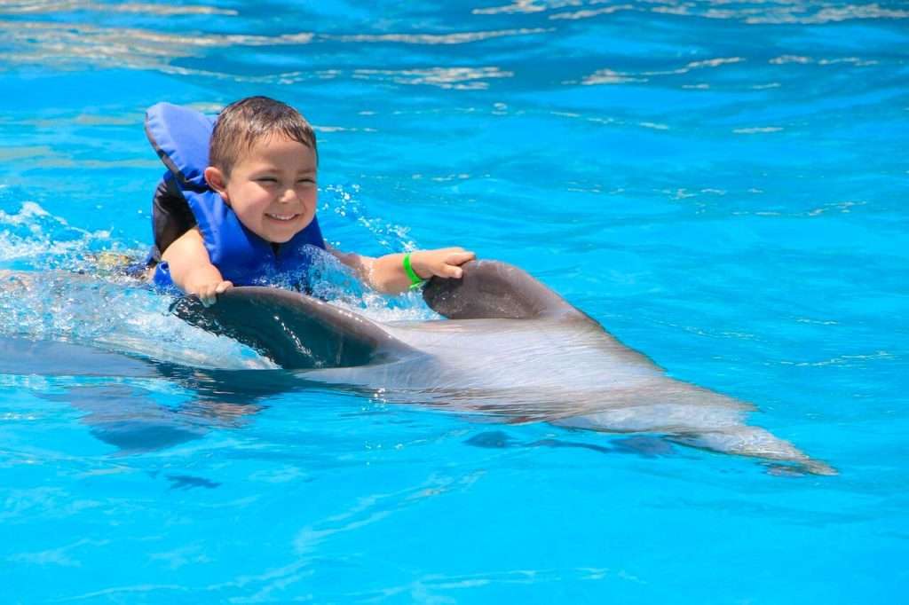 Riding a dolphin in Puerto Vallarta.