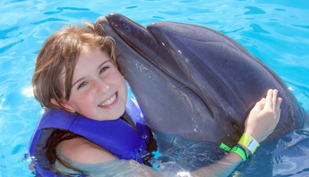 Girl hugging Dolphin in Vallarta.