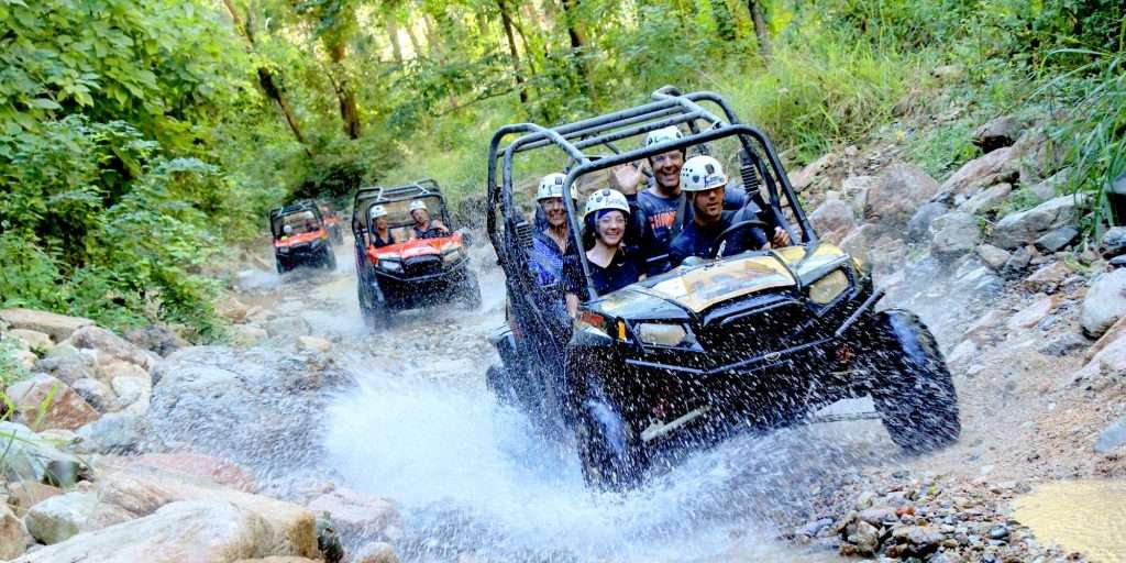 ATVs splash in river in Vallarta, Mexico