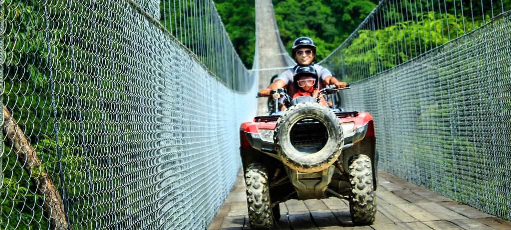 ATV crossing bridge at Canopy River in Vallarta, Mexico.