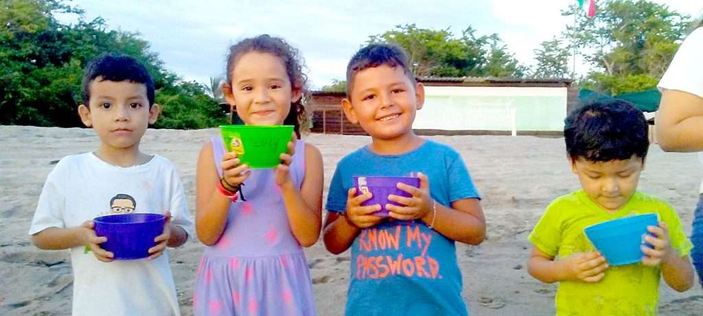 Kids with baby turtles in Vallarta, Mexico.