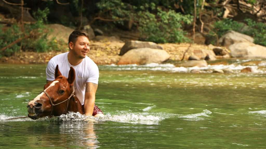Crossingf a river on horseback, Puerto Vallarta.